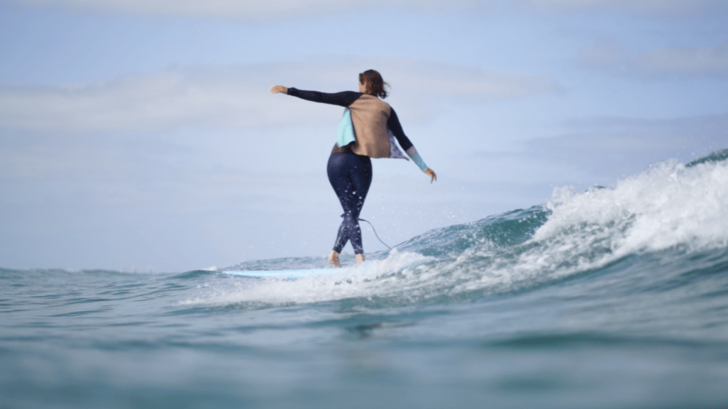 surf girl cross step on longboard